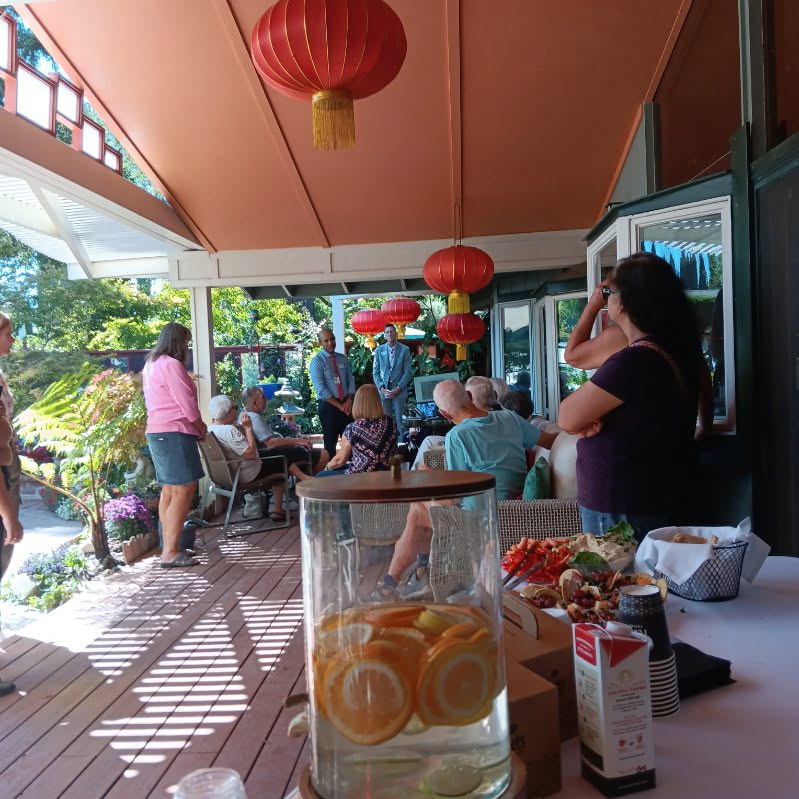 Guests listening under lanterns